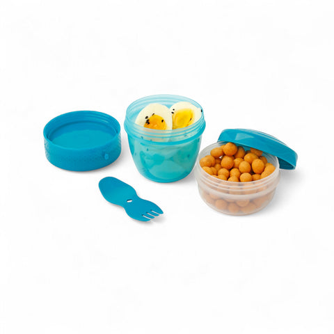 Banana Happy Cup 500 ml snack containers with lid, one filled with hard-boiled eggs, the other with nuts. Includes a blue 2-in-1 fork-spoon.
شوكه و معلقه ، علبه سناكس ، كب زبادى
