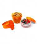 Banana Happy Cup 500 ml snack containers with 2-in-1 fork/spoon, one filled with cereal, one with berries.
شوكه و معلقه ، علبه سناكس ، كب زبادى