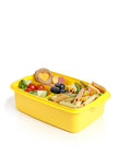 Banana 1.5L yellow lunch box with removable splitter, filled with pasta, vegetables, blueberries, and a heart-shaped sandwich.