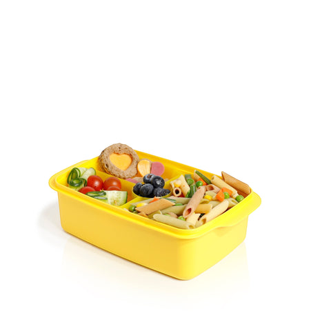 Banana 1.5L yellow lunch box with removable splitter, filled with pasta, vegetables, blueberries, and a heart-shaped sandwich.