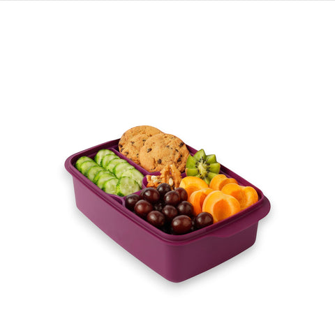Banana 1.5L purple lunch box with removable splitter filled with cookies, grapes, cucumber slices, apricots, kiwi, and nuts.